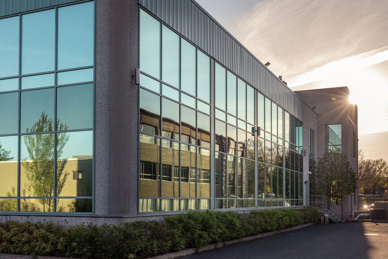 Glass-fronted office building at sunset
